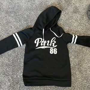 Pink hoodie, no pocket. Size small. Black with white lines/word.
